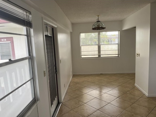 495 Fanshaw L Unit 495, Boca Raton, FL 33434 - tiled spare room featuring a textured ceiling and baseboards