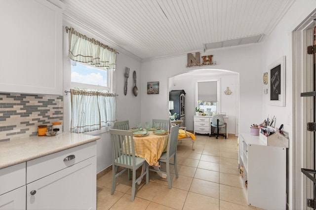 406 N D St, Lake Worth Beach, FL 33460 - dining space with arched walkways, light tile patterned floors, and ornamental molding