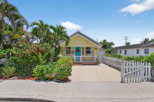 406 N D St, Lake Worth Beach, FL 33460 - bungalow with a porch and a fenced front yard