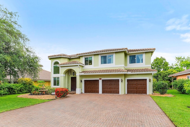 5783 NW 48th Ct, Coral Springs, FL 33067 - mediterranean / spanish house with a garage, decorative driveway, a front lawn, and a tile roof