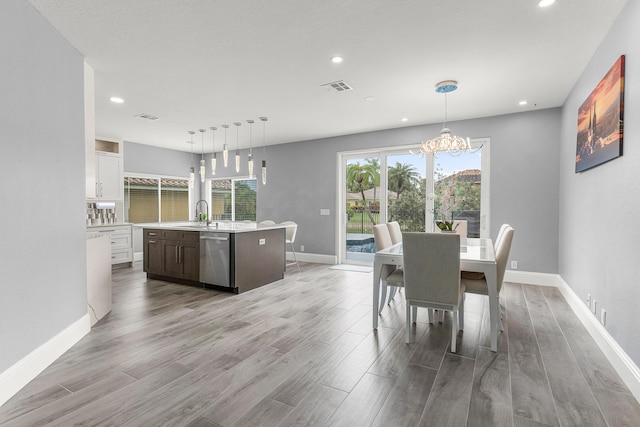 5783 NW 48th Ct, Coral Springs, FL 33067 - dining area featuring a chandelier, light wood-style floors, and recessed lighting