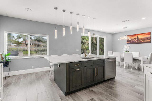 5783 NW 48th Ct, Coral Springs, FL 33067 - kitchen featuring stainless steel dishwasher, light wood-type flooring, recessed lighting, plenty of natural light, and a center island with sink