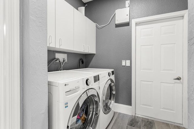 5783 NW 48th Ct, Coral Springs, FL 33067 - washroom with a textured wall, wood finished floors, cabinet space, and washing machine and dryer