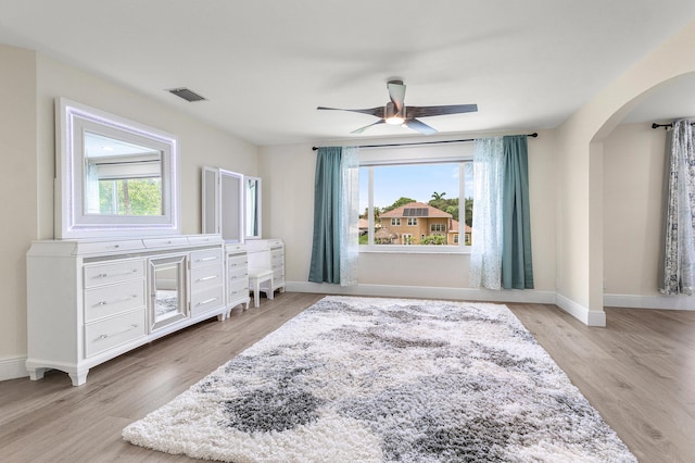 5783 NW 48th Ct, Coral Springs, FL 33067 - bedroom with arched walkways, light wood-style flooring, and a ceiling fan