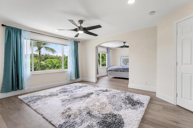 5783 NW 48th Ct, Coral Springs, FL 33067 - bedroom featuring wood finished floors, arched walkways, recessed lighting, and ceiling fan