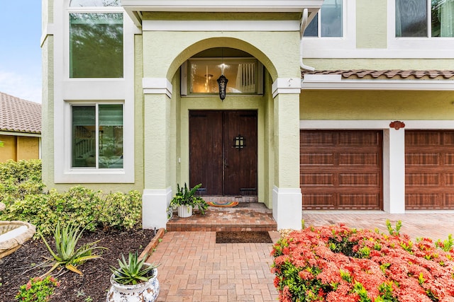 5783 NW 48th Ct, Coral Springs, FL 33067 - doorway to property with stucco siding and a garage