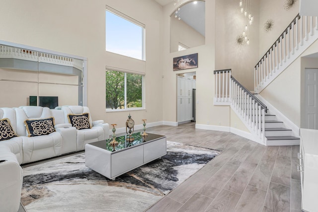 5783 NW 48th Ct, Coral Springs, FL 33067 - living room featuring a high ceiling, stairs, and wood finished floors