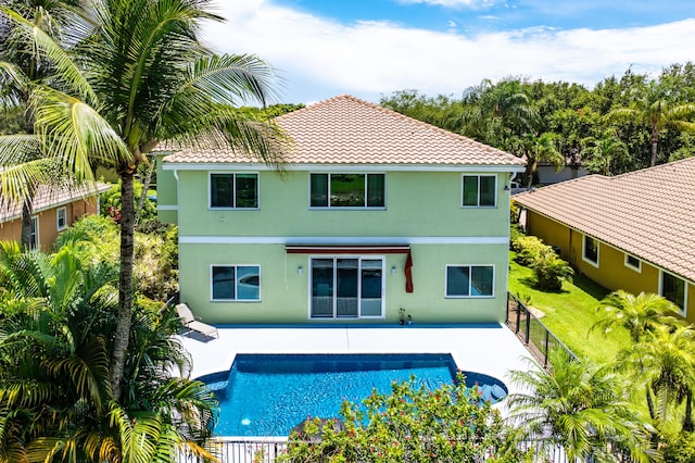 5783 NW 48th Ct, Coral Springs, FL 33067 - back of property with stucco siding, a patio area, a tile roof, and a fenced backyard