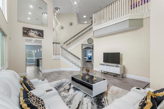 5783 NW 48th Ct, Coral Springs, FL 33067 - living room with stairs, arched walkways, a high ceiling, wood finished floors, and recessed lighting