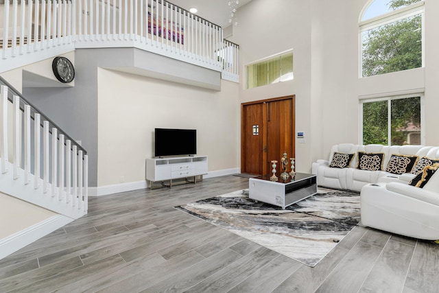 5783 NW 48th Ct, Coral Springs, FL 33067 - living area with a high ceiling, wood finished floors, and stairs