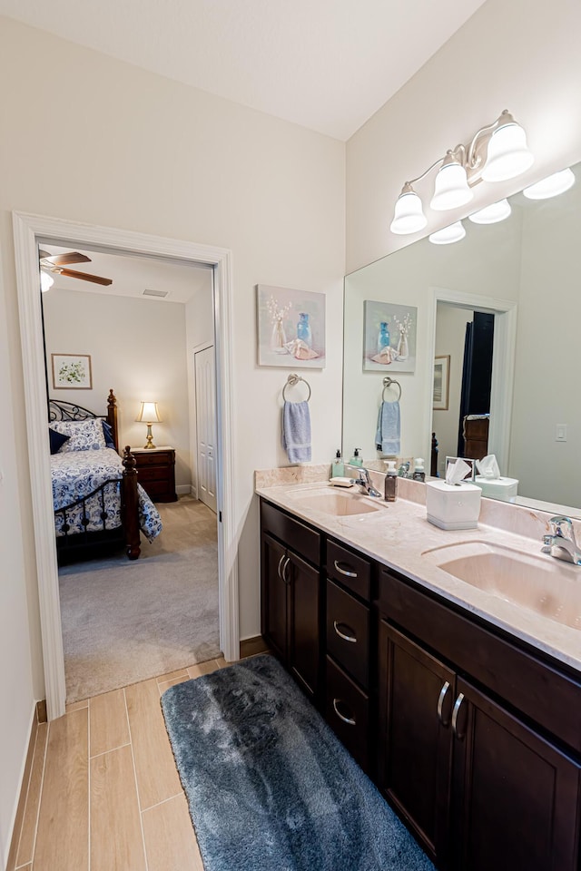 5927 NW Favian Ave, Port Saint Lucie, FL 34986 - bathroom featuring double vanity, connected bathroom, and ceiling fan