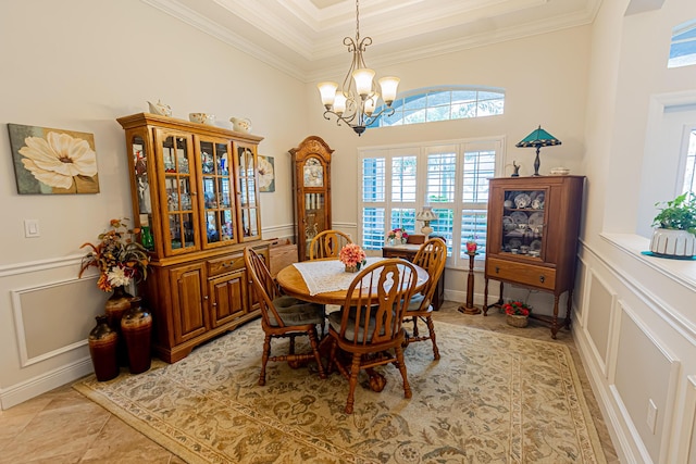 5927 NW Favian Ave, Port Saint Lucie, FL 34986 - dining area with a decorative wall, a chandelier, crown molding, healthy amount of natural light, and a high ceiling