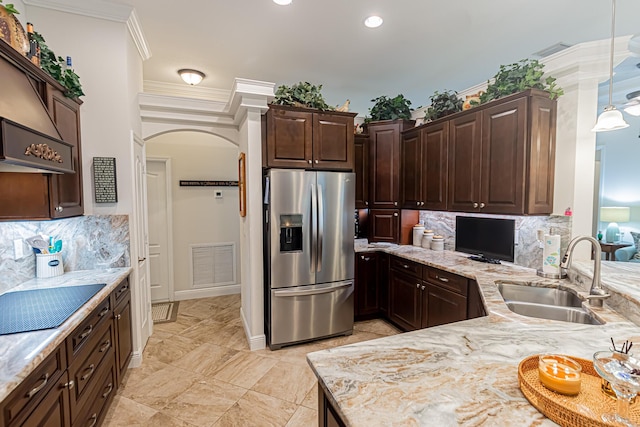 5927 NW Favian Ave, Port Saint Lucie, FL 34986 - kitchen featuring stainless steel refrigerator with ice dispenser, black electric cooktop, arched walkways, tasteful backsplash, and ornamental molding