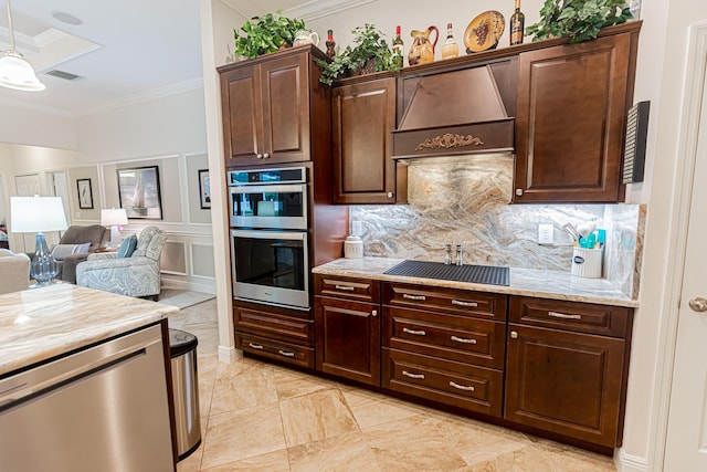5927 NW Favian Ave, Port Saint Lucie, FL 34986 - kitchen with stainless steel appliances, custom range hood, crown molding, decorative backsplash, and dark brown cabinetry