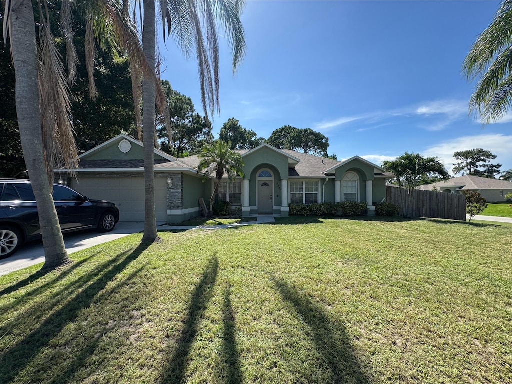 2402 SW Massey St, Port Saint Lucie, FL 34953 - single story home featuring a garage, stucco siding, and concrete driveway