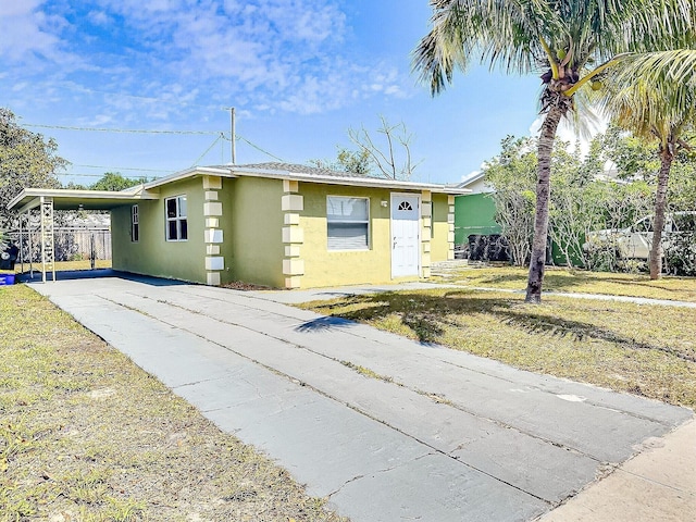 1206 Crestwood Blvd, Lake Worth, FL 33460 - view of front of home with concrete driveway, stucco siding, and a carport