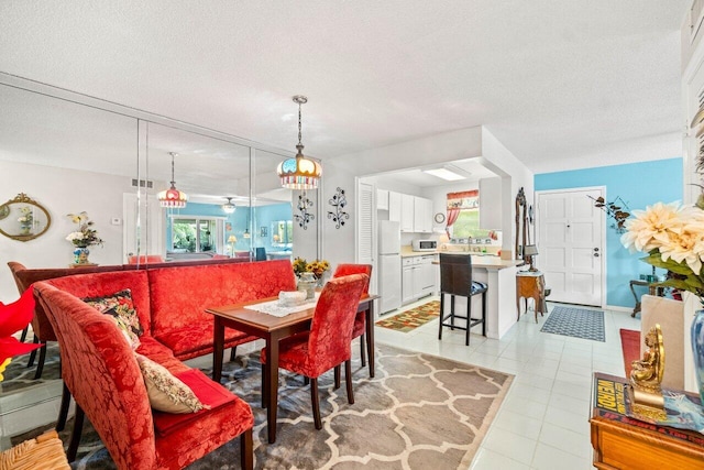 1124 NW 13th St Unit 204A, Boca Raton, FL 33486 - dining space featuring healthy amount of natural light, a textured ceiling, and light tile patterned flooring