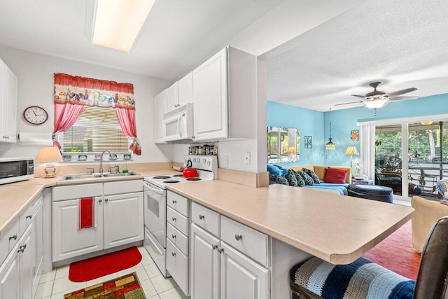 1124 NW 13th St Unit 204A, Boca Raton, FL 33486 - kitchen with white appliances, open floor plan, light tile patterned flooring, white cabinets, and a ceiling fan