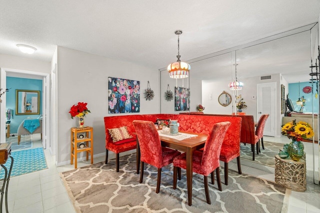 1124 NW 13th St Unit 204A, Boca Raton, FL 33486 - tiled dining room with a chandelier and baseboards