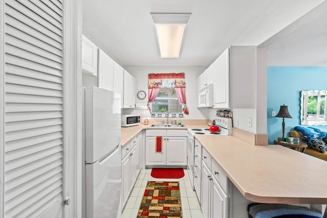 1124 NW 13th St Unit 204A, Boca Raton, FL 33486 - kitchen with white appliances, plenty of natural light, and white cabinetry