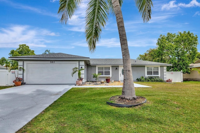 557 SW Violet Ave, Port Saint Lucie, FL 34983 - ranch-style house featuring a garage, stucco siding, and driveway