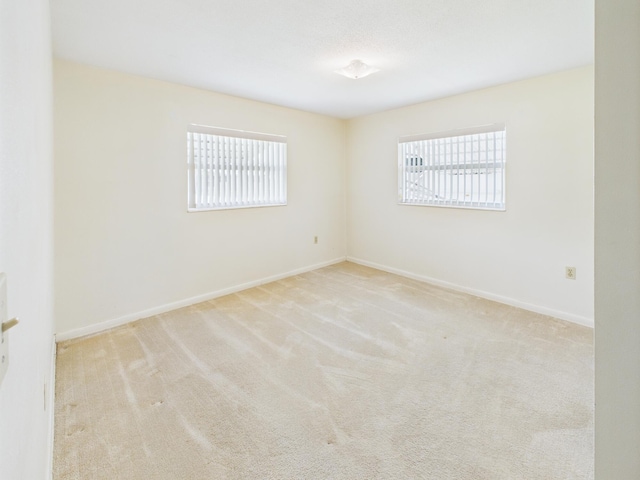 810 SE 13th St, Okeechobee, FL 34974 - carpeted empty room featuring healthy amount of natural light