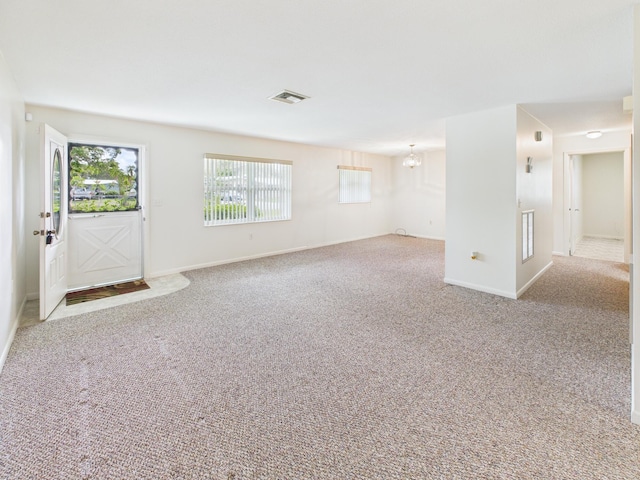 810 SE 13th St, Okeechobee, FL 34974 - foyer entrance with a chandelier and carpet