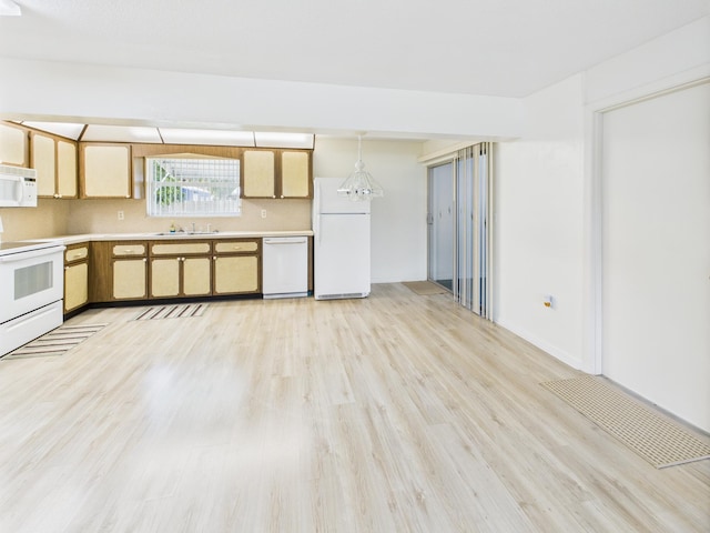 810 SE 13th St, Okeechobee, FL 34974 - kitchen featuring white appliances, light wood finished floors, and light countertops