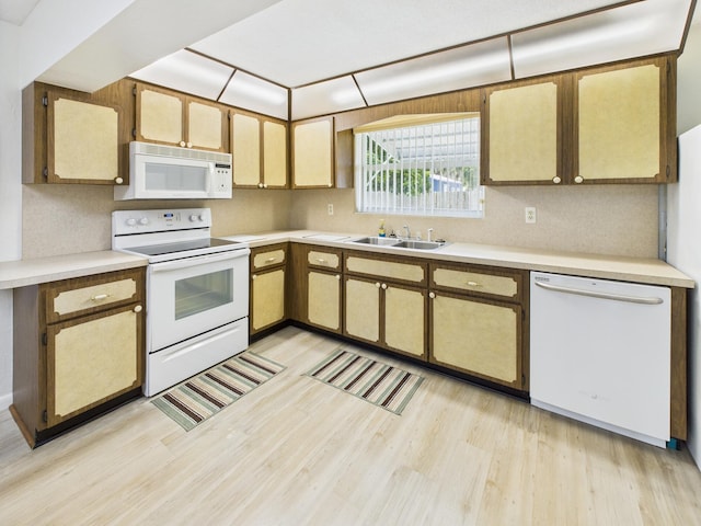 810 SE 13th St, Okeechobee, FL 34974 - kitchen featuring white appliances, light wood-style floors, and light countertops