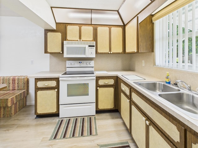 810 SE 13th St, Okeechobee, FL 34974 - kitchen with white appliances, light wood-type flooring, and light countertops