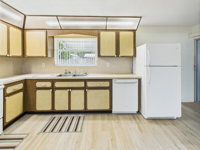 810 SE 13th St, Okeechobee, FL 34974 - kitchen with white appliances, light wood finished floors, light countertops, and decorative backsplash