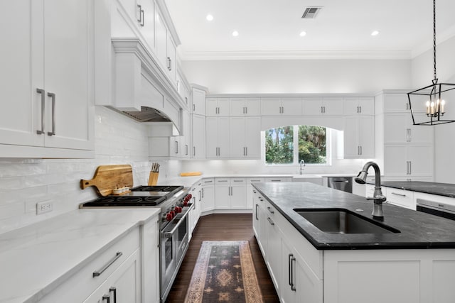 1257 Breakers W Blvd, West Palm Beach, FL 33411 - kitchen with double oven range, crown molding, dark wood finished floors, an island with sink, and white cabinets