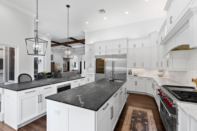1257 Breakers W Blvd, West Palm Beach, FL 33411 - kitchen featuring a large island, high end appliances, ornamental molding, premium range hood, and tasteful backsplash