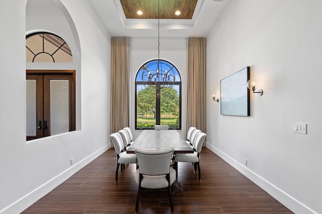 1257 Breakers W Blvd, West Palm Beach, FL 33411 - dining area featuring a tray ceiling, dark wood-type flooring, recessed lighting, and a towering ceiling