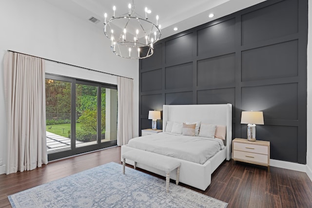 1257 Breakers W Blvd, West Palm Beach, FL 33411 - bedroom with a decorative wall, access to exterior, dark wood-type flooring, a high ceiling, and a chandelier