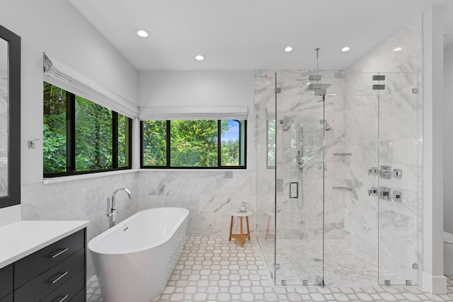 1257 Breakers W Blvd, West Palm Beach, FL 33411 - full bath featuring a freestanding bath, a marble finish shower, recessed lighting, vanity, and tile walls