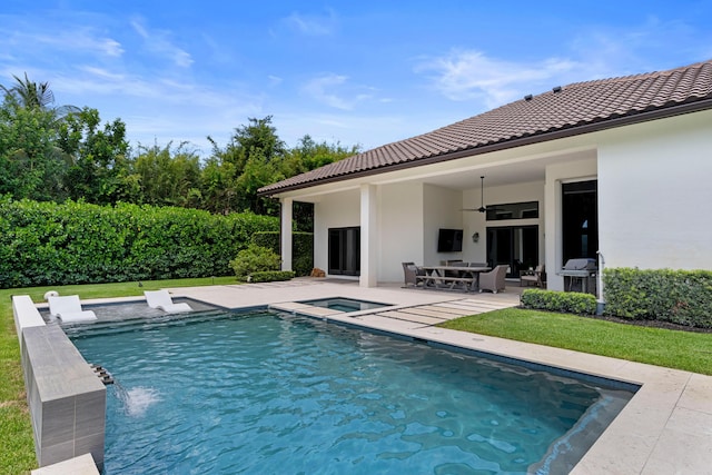 1257 Breakers W Blvd, West Palm Beach, FL 33411 - view of swimming pool with an in-ground hot tub, ceiling fan, a patio area, and a yard