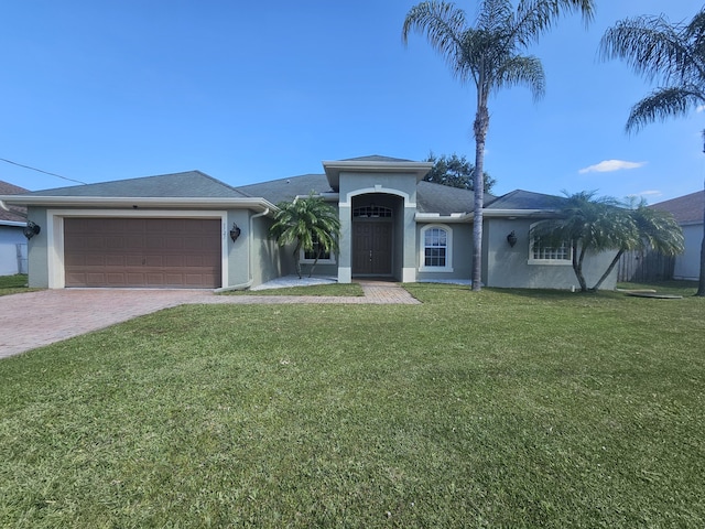 5721 NW Alcazar Ter, Port Saint Lucie, FL 34986 - ranch-style house with stucco siding, a garage, decorative driveway, and a front yard