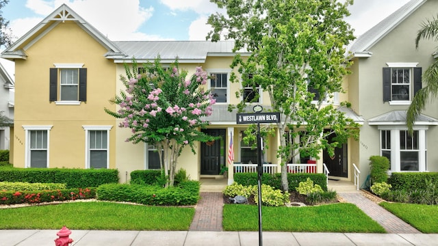 10468 SW Westlawn Blvd, Port Saint Lucie, FL 34987 - townhome / multi-family property with stucco siding and a porch