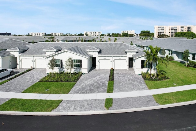 14511 Three Ponds Trl, Delray Beach, FL 33446 - view of front facade featuring decorative driveway, an attached garage, a front yard, and stucco siding