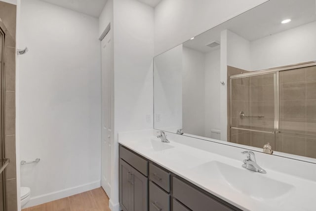 14511 Three Ponds Trl, Delray Beach, FL 33446 - full bath with double vanity, wood finished floors, and a tile shower