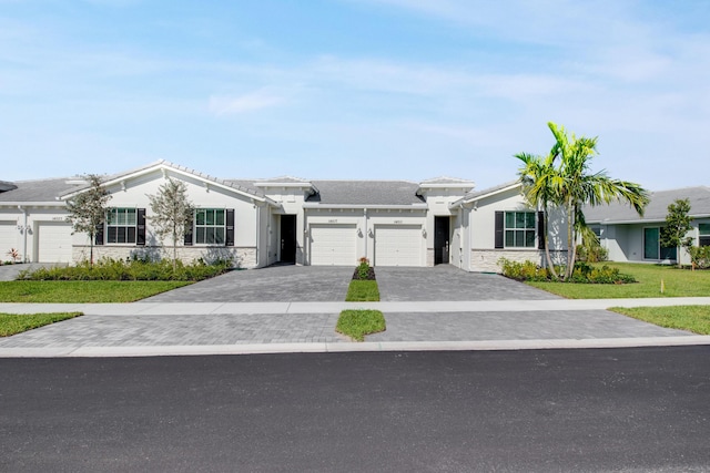 14511 Three Ponds Trl, Delray Beach, FL 33446 - ranch-style home featuring an attached garage, decorative driveway, stone siding, and stucco siding