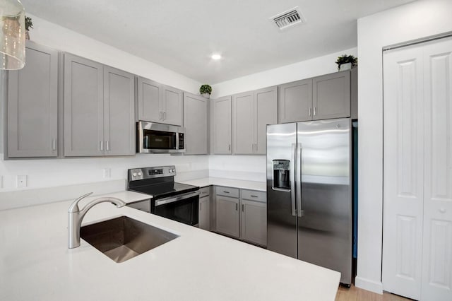 14511 Three Ponds Trl, Delray Beach, FL 33446 - kitchen with appliances with stainless steel finishes, gray cabinetry, light countertops, and recessed lighting