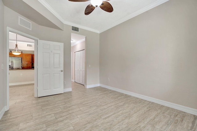 40 SE Sedona Cir Unit 104, Stuart, FL 34994 - unfurnished bedroom with stainless steel refrigerator with ice dispenser, a closet, crown molding, light wood-type flooring, and ceiling fan