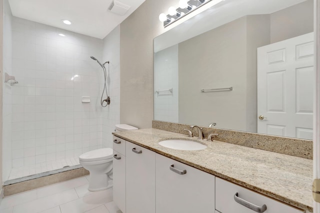 40 SE Sedona Cir Unit 104, Stuart, FL 34994 - full bathroom with vanity, tiled shower, and tile patterned flooring