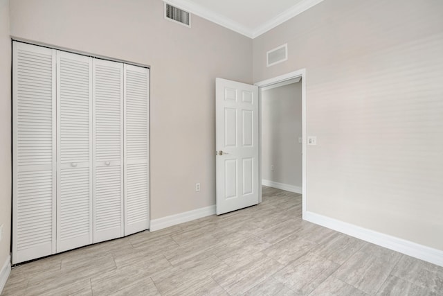 40 SE Sedona Cir Unit 104, Stuart, FL 34994 - unfurnished bedroom with crown molding and a closet