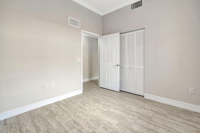40 SE Sedona Cir Unit 104, Stuart, FL 34994 - unfurnished bedroom with ornamental molding, a closet, and a towering ceiling