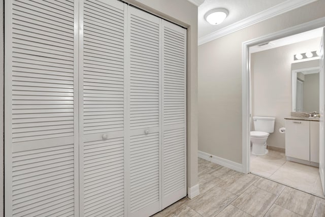 40 SE Sedona Cir Unit 104, Stuart, FL 34994 - corridor featuring ornamental molding and baseboards