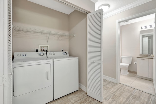 40 SE Sedona Cir Unit 104, Stuart, FL 34994 - washroom featuring washing machine and dryer and baseboards