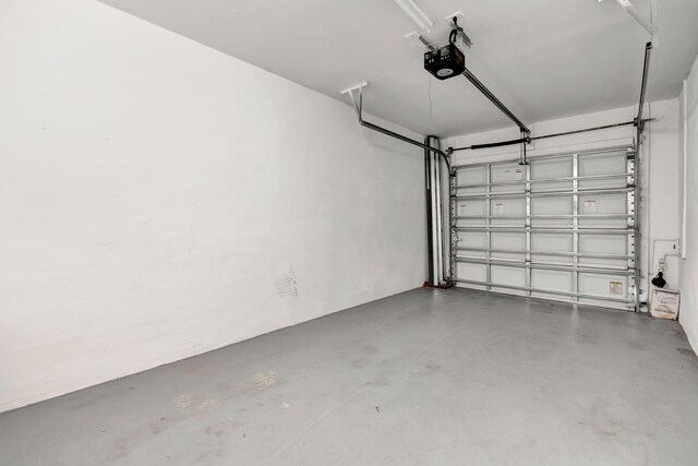40 SE Sedona Cir Unit 104, Stuart, FL 34994 - garage featuring a garage door opener